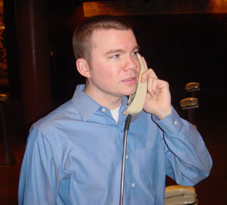 Bill Cash making a phone call at Franklin Court's underground museum, Philadelphia